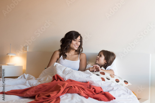 Mother and daughter in bed