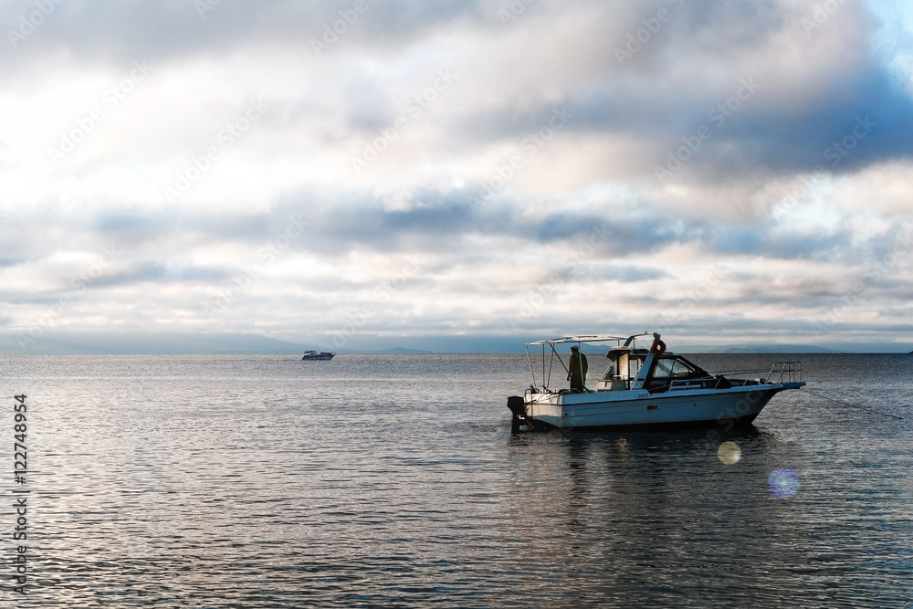 High speed white yacht or motor boat in open sea at sunset. High speed white yacht or motor boat in open sea at sunset.