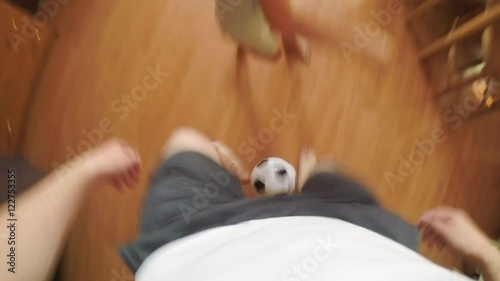 POV: Father plays football with a son at home