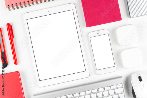Top view: Keyboard, mouse, tablet computer and smartphone on white table background with space for text and copy space.