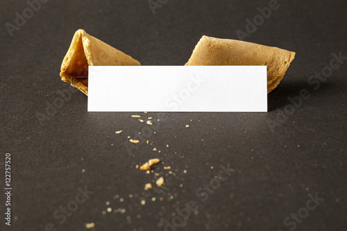 a fortune cookie with a blank paper for your message photo