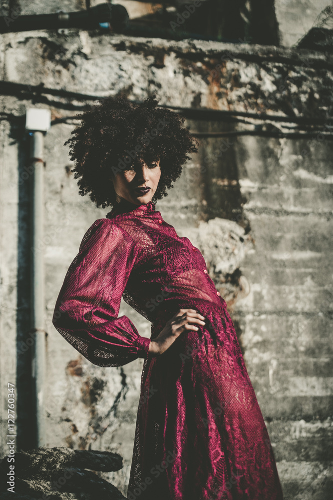 Stylish young latin woman posing in purple dress Stylish young latin woman posing in purple dress