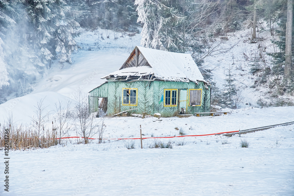 Winter landscape. Old wooden abandoned house