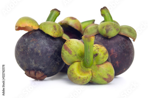 Mangosteen fruit with half cross section isolated on white