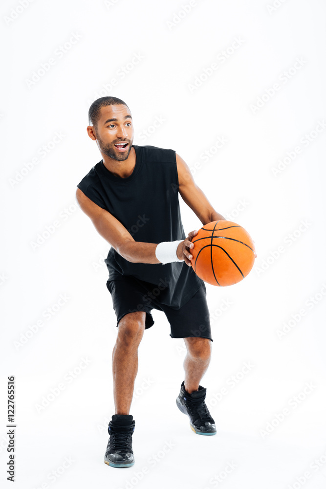 Full length portrait of a smiling sports man playing basketball Full length portrait of a smiling sports man playing basketball
