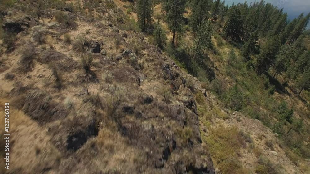 Drone Pilot Flying with Remote on Top of Rocky Mountain Cliff Drone Pilot Flying with Remote on Top of Rocky Mountain Cliff