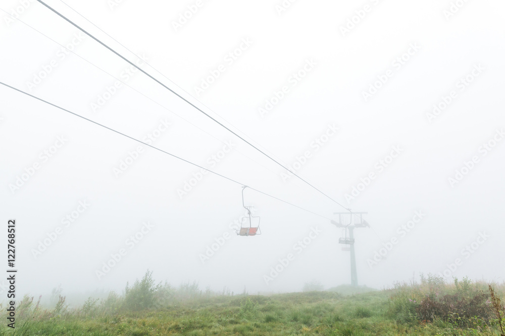 Chair lift in the fog