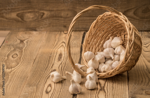 garlic in a basket on a wooden table