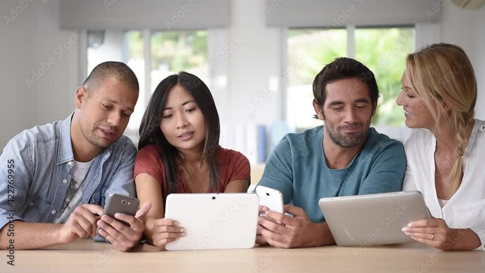 Start-up business people meeting with tablets and smartphones Start-up business people meeting with tablets and smartphones