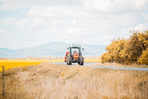 Farm tractor drives on road