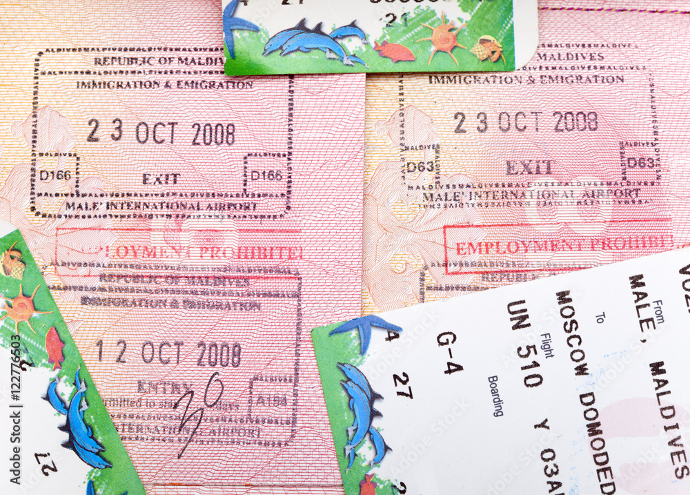 Opened passport with Maldives visa stamps and airline boading pass  tickets.. Stock Photo | Adobe Stock