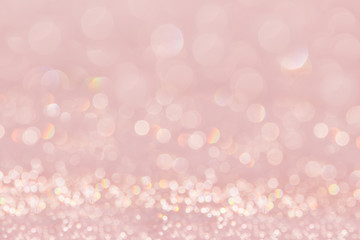 Bokeh soft pastel pink background with blurred golden lights. Festive background.