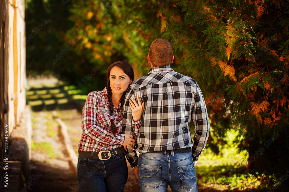 Wife hugging her husband. A man stands with his back. Wife hugging her husband. A man stands with his back.