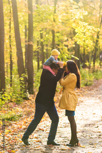 Happy family mother, father and baby in autumn nature © satura_