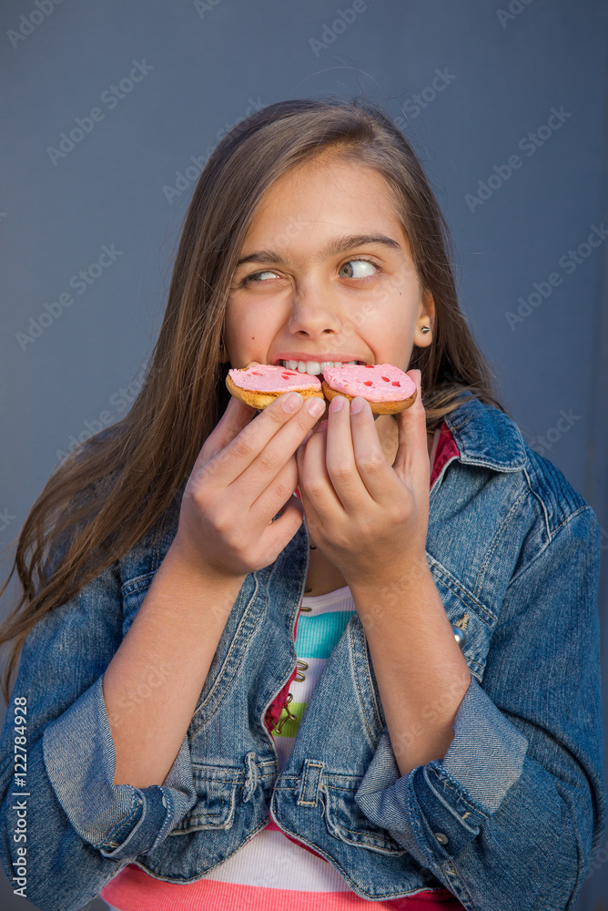 Girl eating cookies, snack for teenagers in school time. sweets and bakery concept - smiling little girl eating cookie or biscuit. Girl and cookies. Teen girl eating tasty cookies. Food on the go. 
