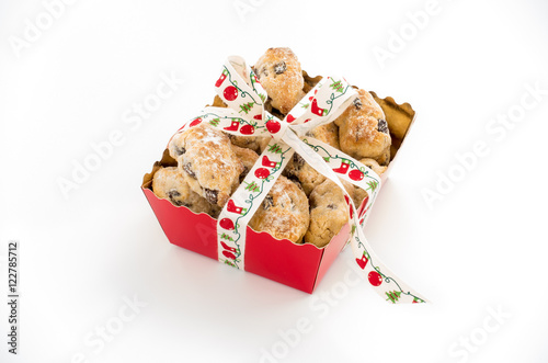 Mini Christstollen in a festive red tray decorated with ribbon isolated on white background.  photo