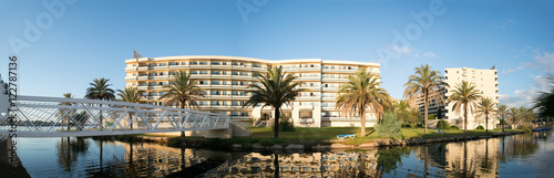 hotels is reflected in the Esperanza lake in Port d'Alcudia. Beautiful reflection of the sky and clouds. Alcudia, Mallorca, Spain.