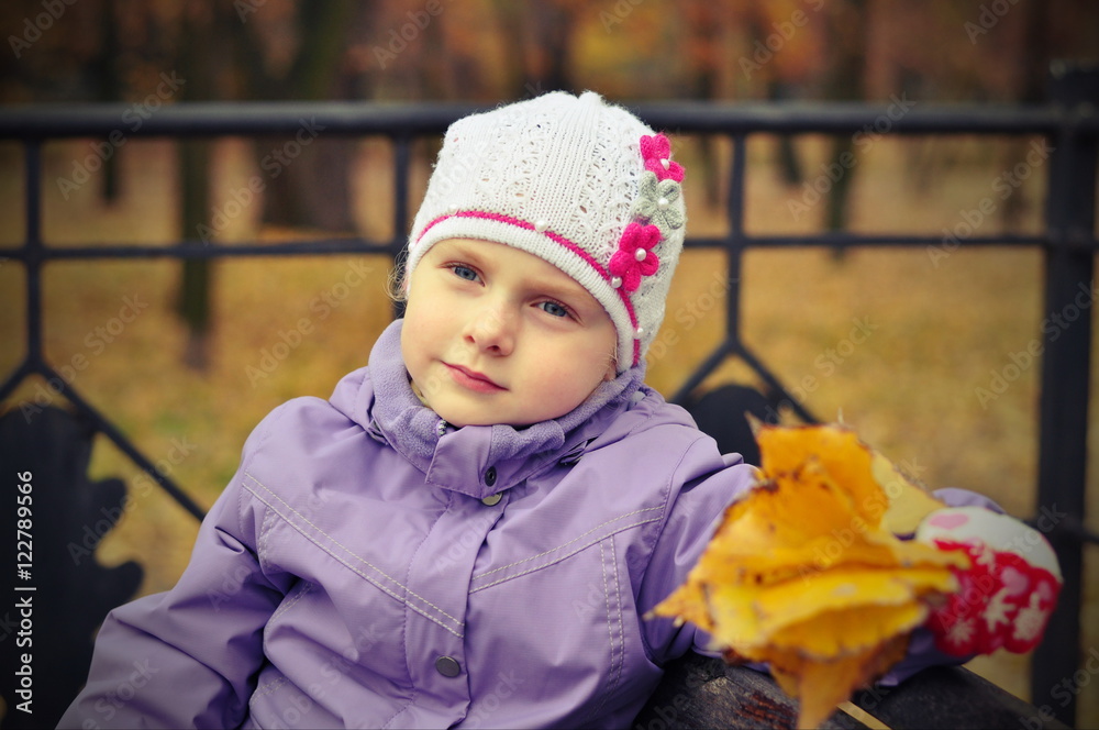 girl sitting on the bench with yellow leaves girl sitting on the bench with yellow leaves