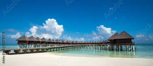Fototapeta Naklejka Na Ścianę i Meble -  Beautiful beach with water bungalows at Maldives, panorama forma