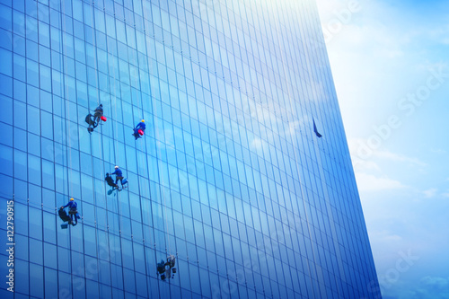 A Team Of Climbing Workers Clean the Windows on Skyscraper