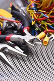 Tools for electrician and cables on metal surface