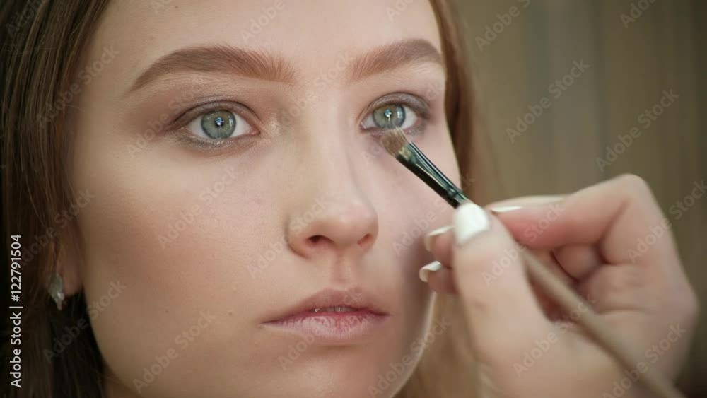 the Make-Up Stylist Doing a Make-Up to Hipster Model the Make-Up Stylist Doing a Make-Up to Hipster Model