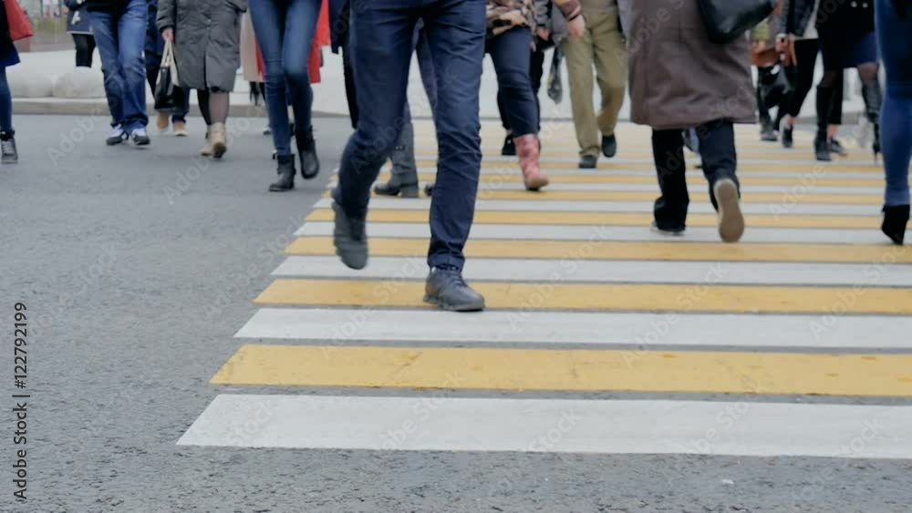 People cross the road at a pedestrian crossing People cross the road at a pedestrian crossing