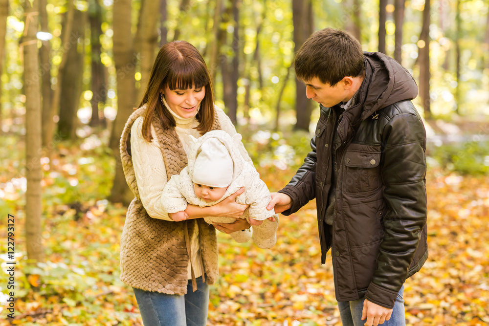 Fototapeta premium Portrait of a happy young couple playing with their cute newborn baby