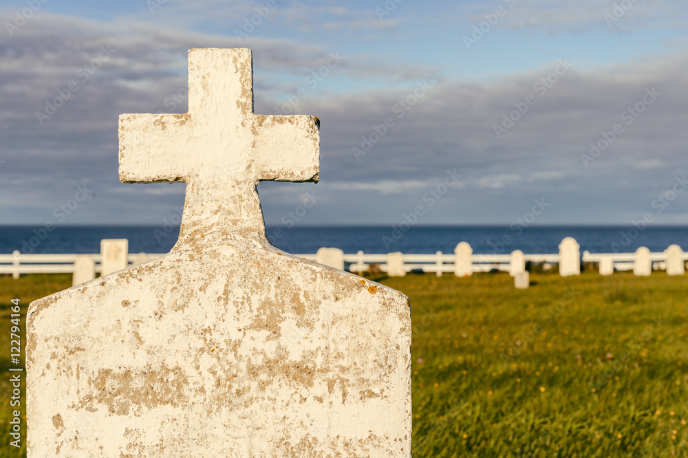 Blank headstone in a cemetery, with ocean in the background Blank headstone in a cemetery, with ocean in the background