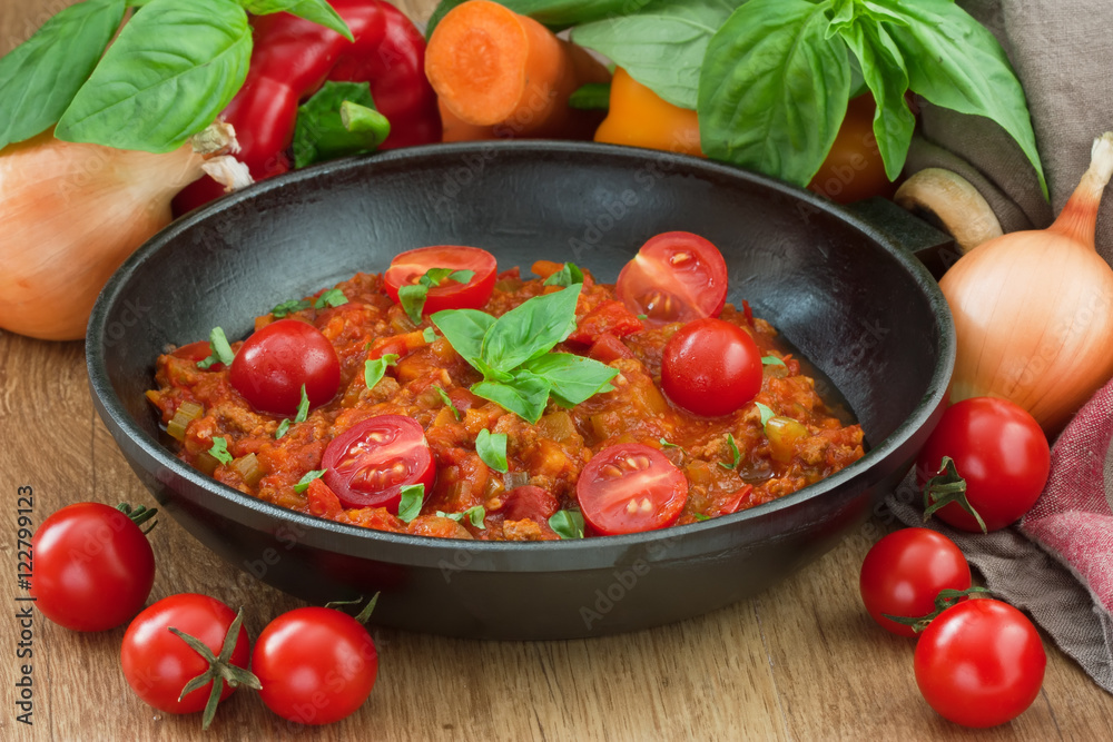 Tomato sauce bolognese / Tomato sauce bolognese for spaghetti with cherry tomato, basil and vegetable on rustic wooden background Tomato sauce bolognese / Tomato sauce bolognese for spaghetti with cherry tomato, basil and vegetable on rustic wooden background