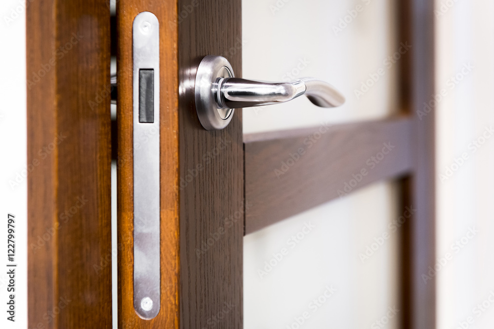 Part of open door with silver door-handle Part of open door with silver door-handle