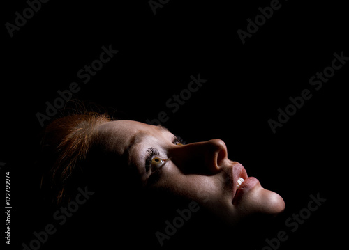 girl looks up in dark