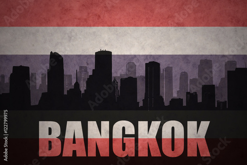 abstract silhouette of the city with text Bangkok at the vintage thailand flag background