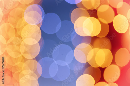 Christmas shiny light bokeh in blue, red and yellow colors, vintage retro hipster seasonal holiday background