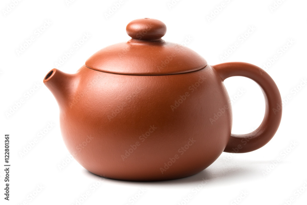 Small brown earthenware teapot with closed lid isolated on white