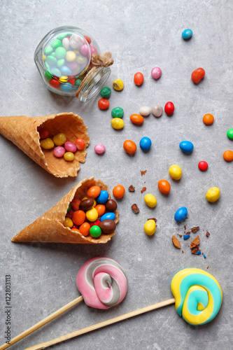Fototapeta Naklejka Na Ścianę i Meble -  Dessert in ice cream cone on gray background