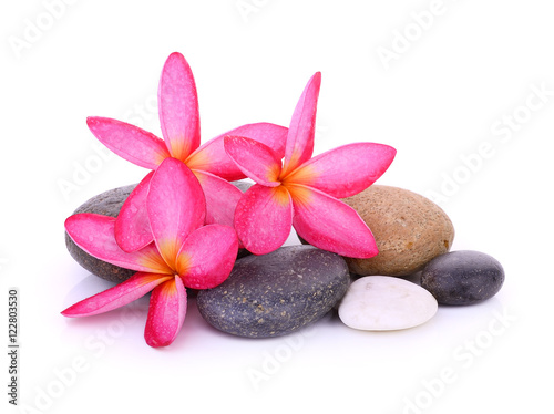 stones with frangipani flower isolated on white