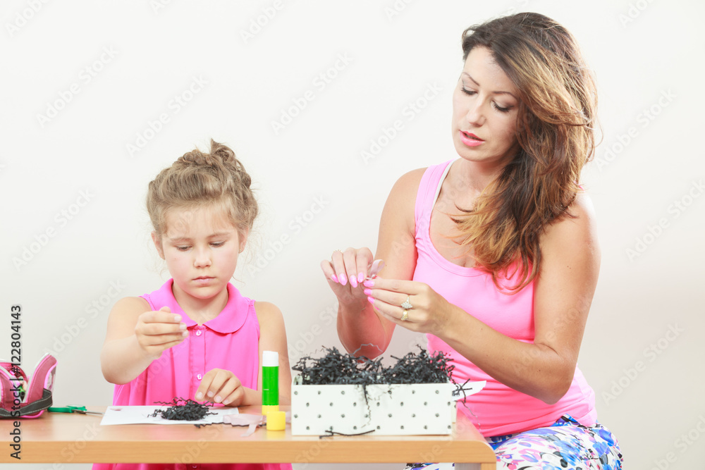 Fototapeta premium Little girl work with mom