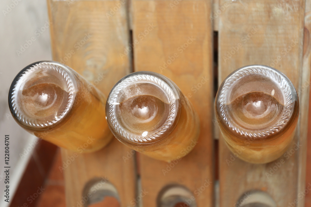 Bottles with wine on shelf in cellar
