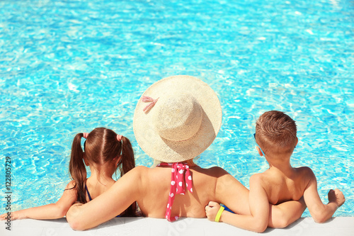 Mother with children in swimming pool at water park