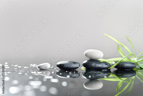 background of a spa with stones  and green leaves