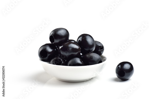 Fotografija Pickled pitted black olives in a bowl isolated on a white background