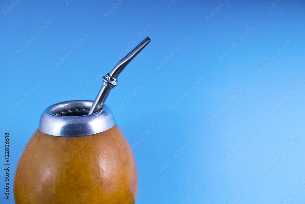 yerba mate with bombilla on blue background yerba mate with bombilla on blue background
