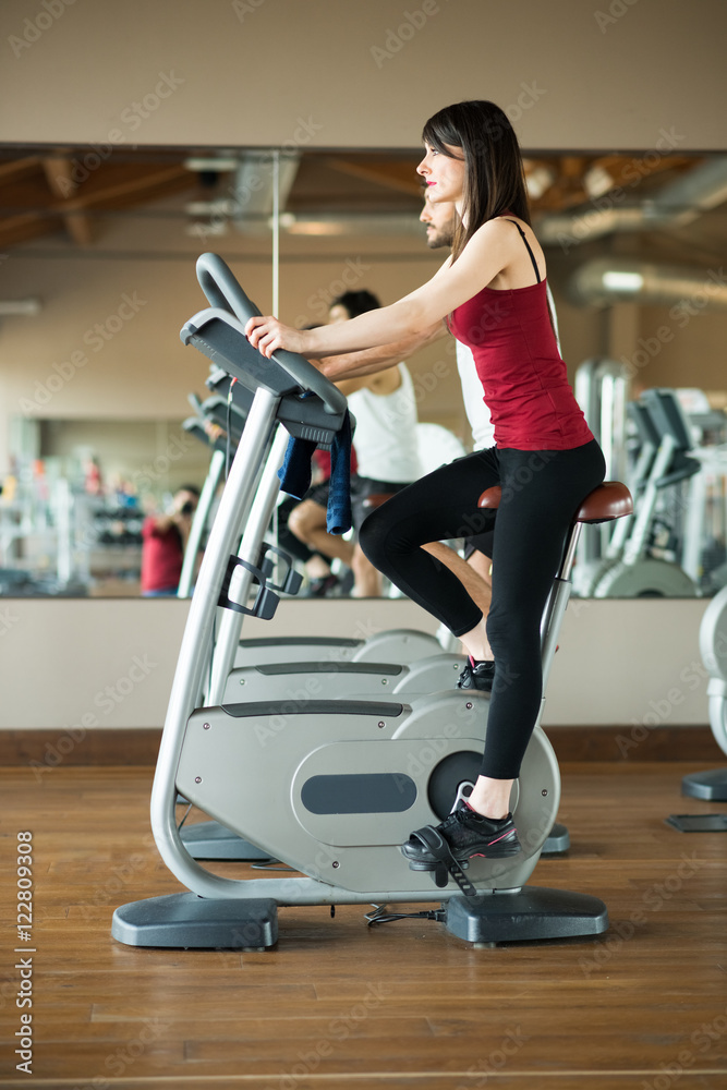 Fototapeta premium Woman working out on a stationary bike