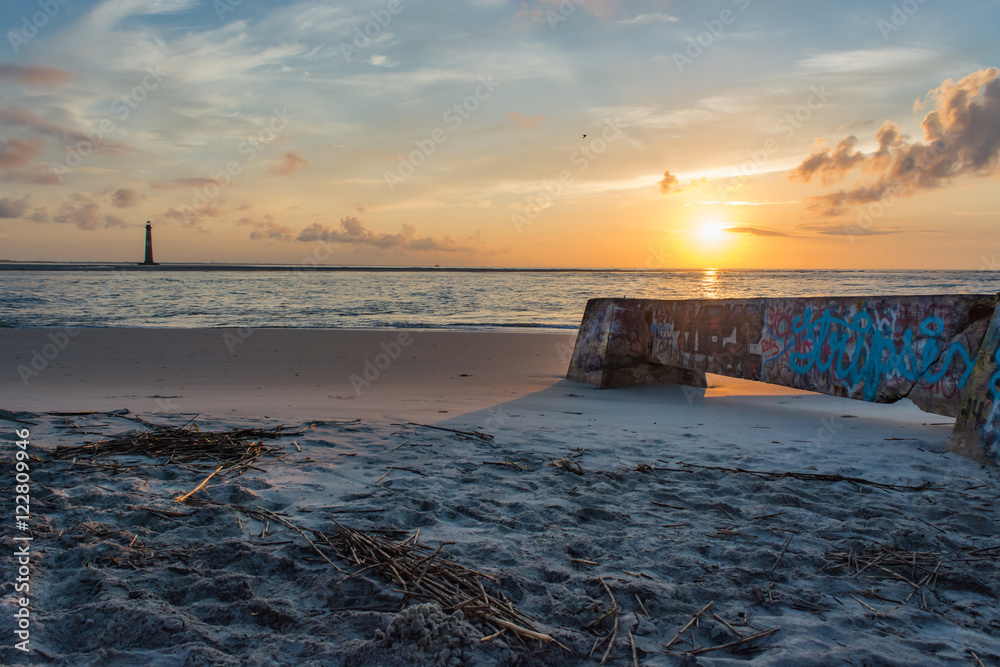 Lighthouse viewed from the beach. Graffiti concrete structure. Folly Beach, South Carolina.