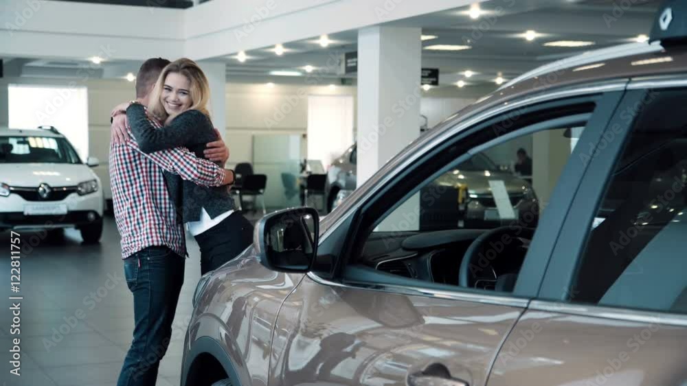 4K Man surprises wife or girlfriend in car dealership, showing new car 4K Man surprises wife or girlfriend in car dealership, showing new car