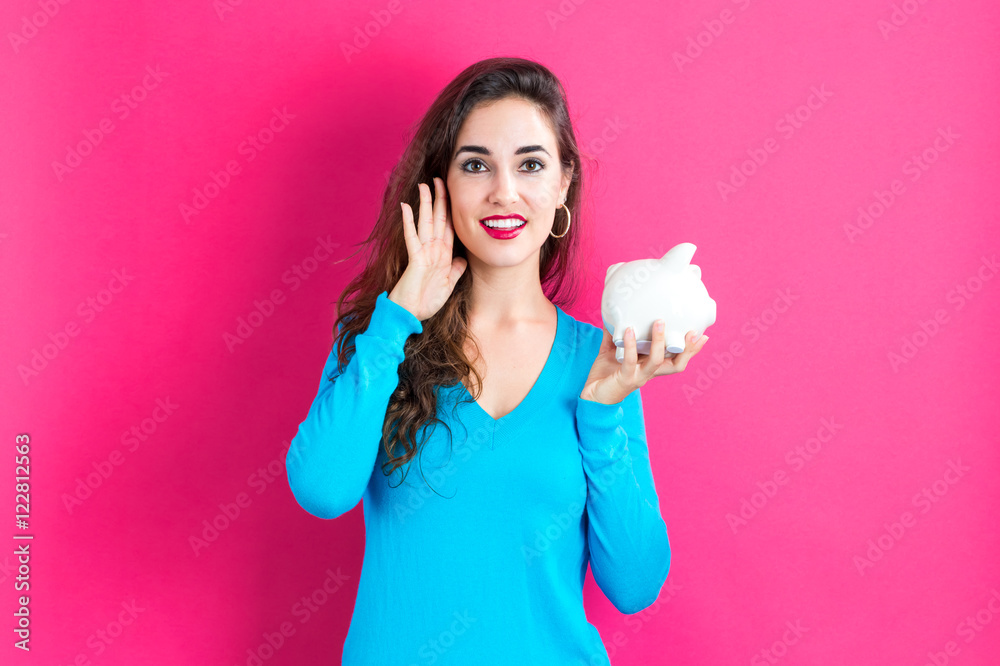 Young woman with a piggy bank