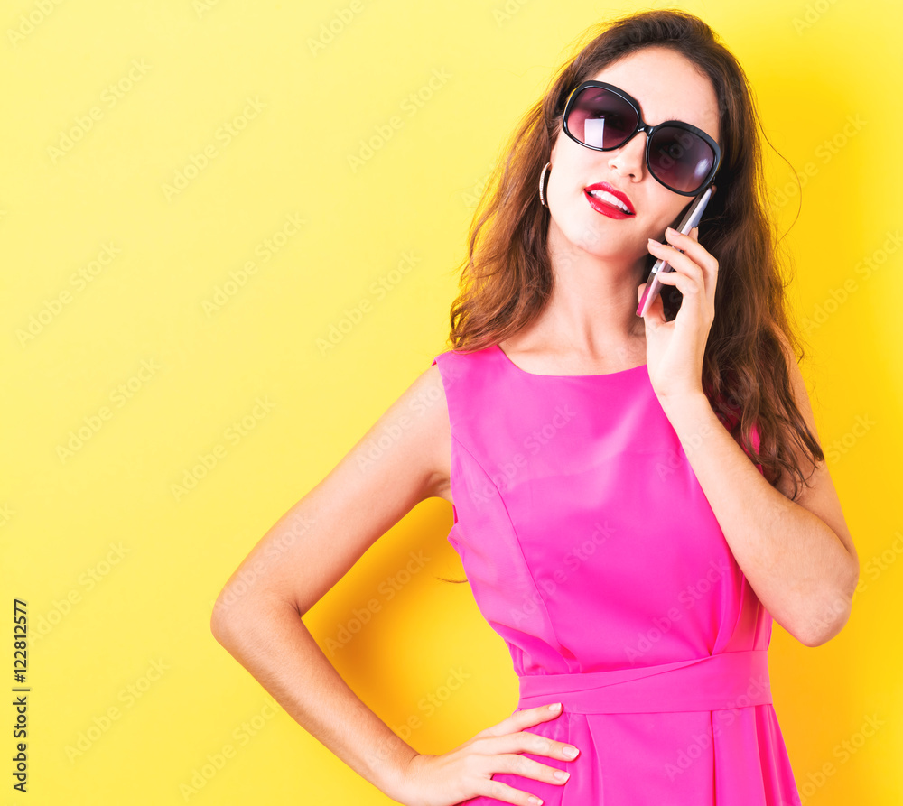 Fototapeta premium Young woman talking on the phone