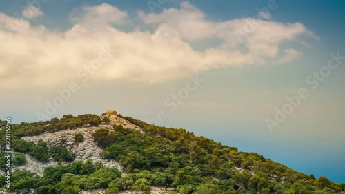 Beautiful landscape with a little house in rocky mountains on the western part of Mallorca island, Spain. Tramuntana mountains with forest. Tourist trekking destination in Spain. Travel timelapse of a