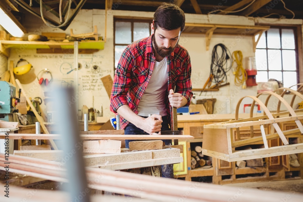 Man working over a wooden plank Man working over a wooden plank